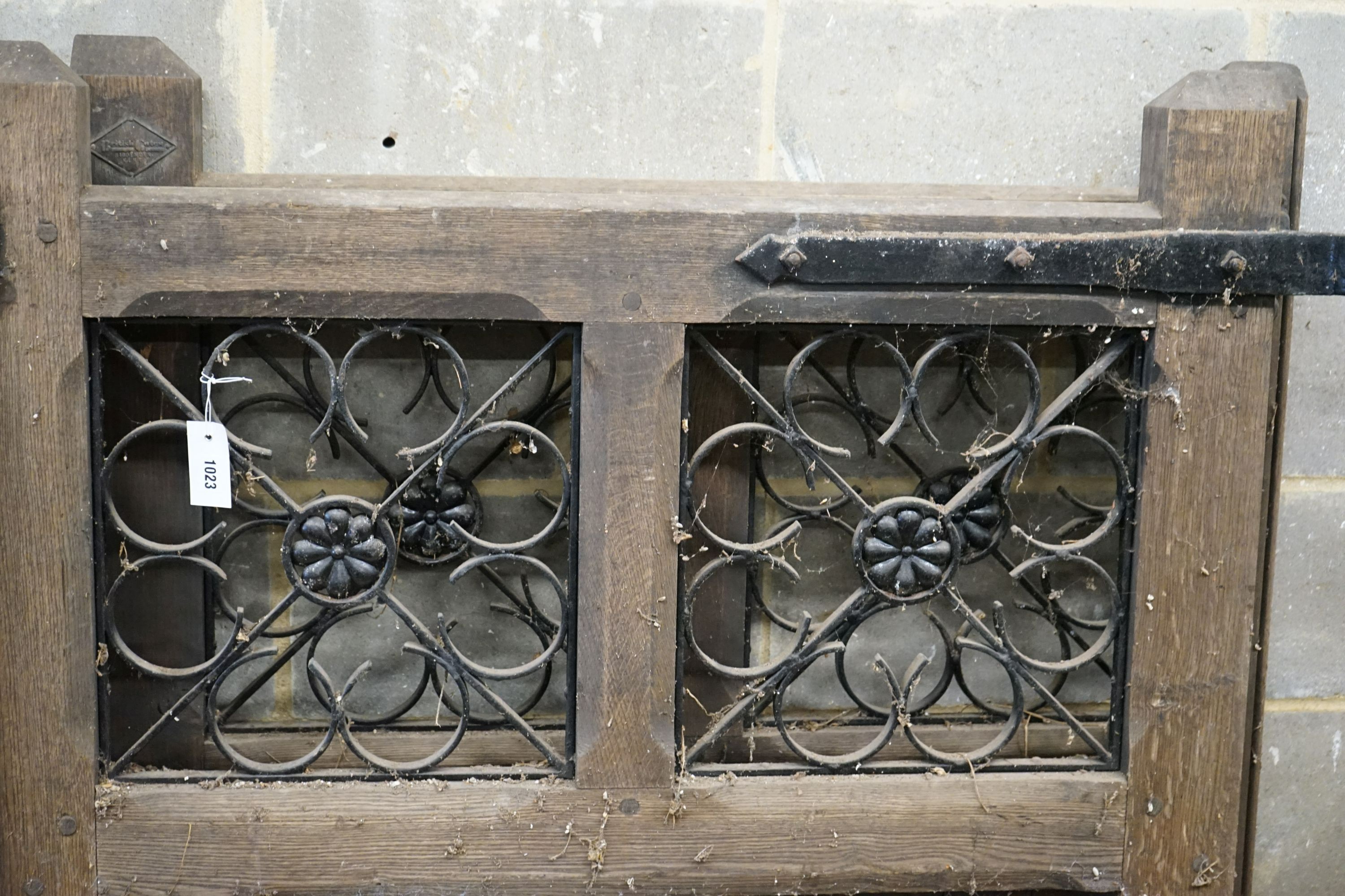 A pair of oak and wrought iron gates, each width 107cm, height 133cm